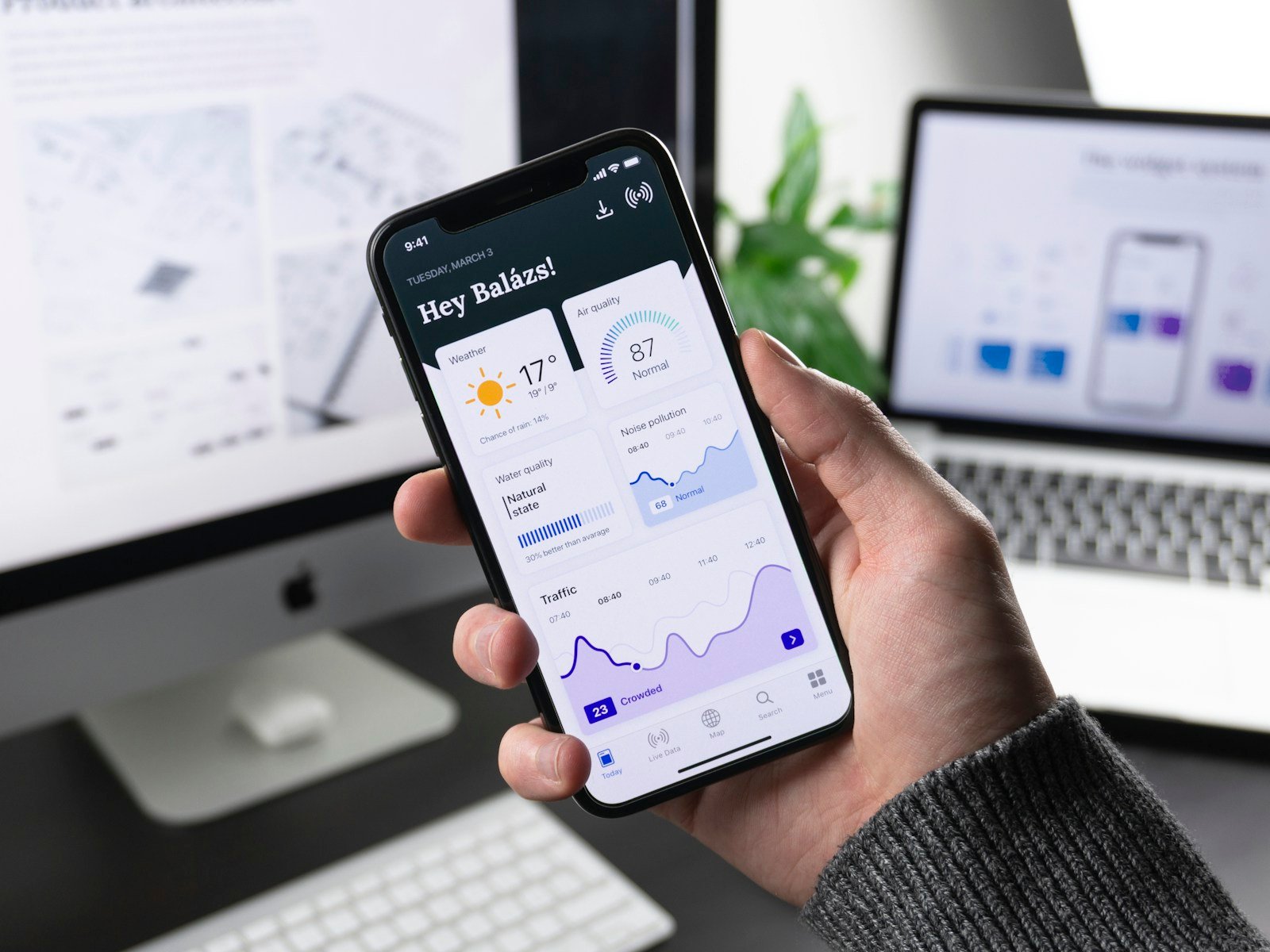 A mobile product interface being reviewed at a studio desk